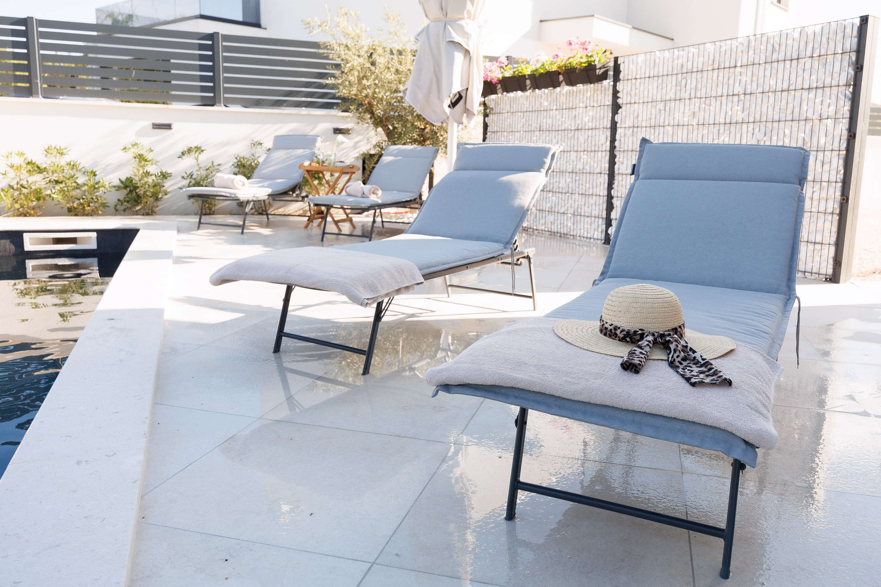 Pool deck loungers with sun hat