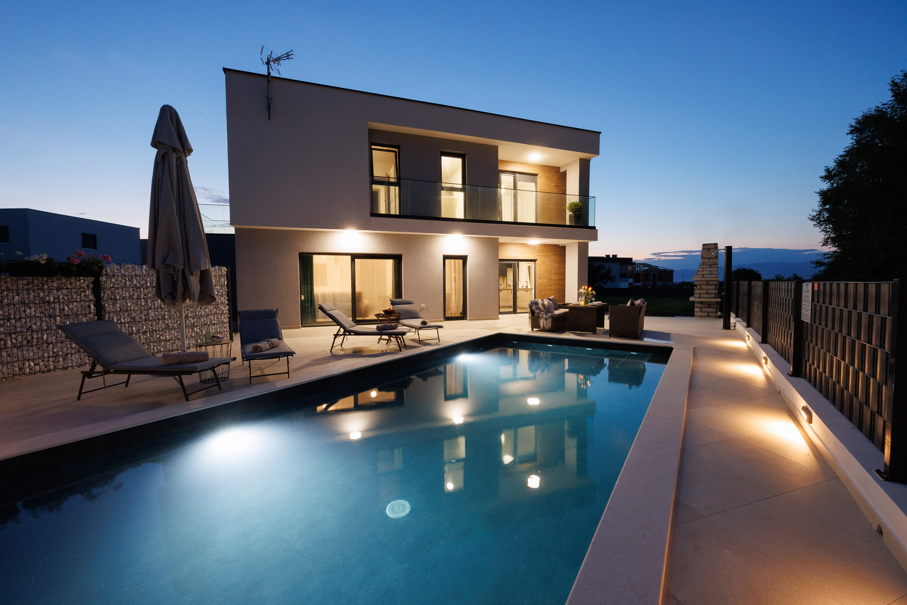 Villa Zara exterior at twilight with lit pool