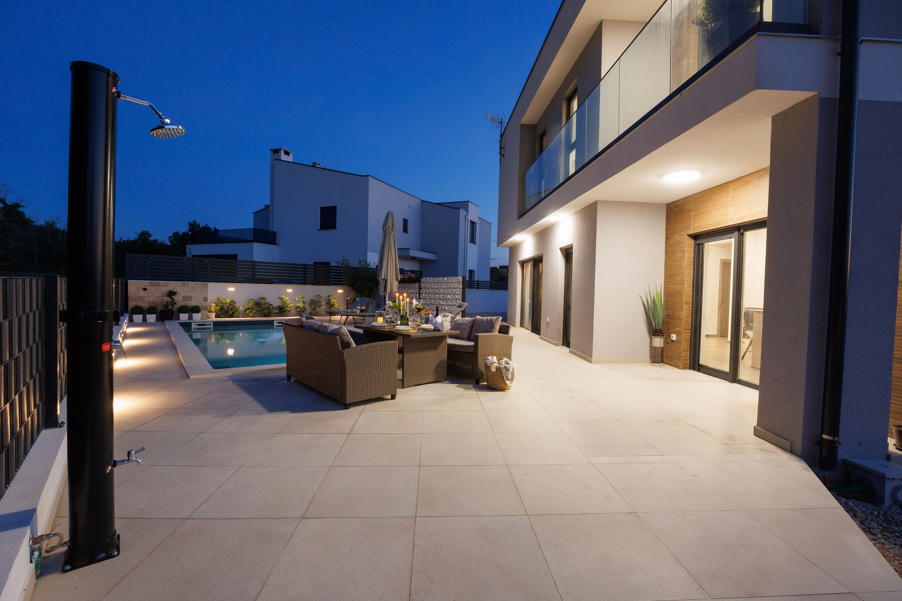 Patio with outdoor shower at dusk
