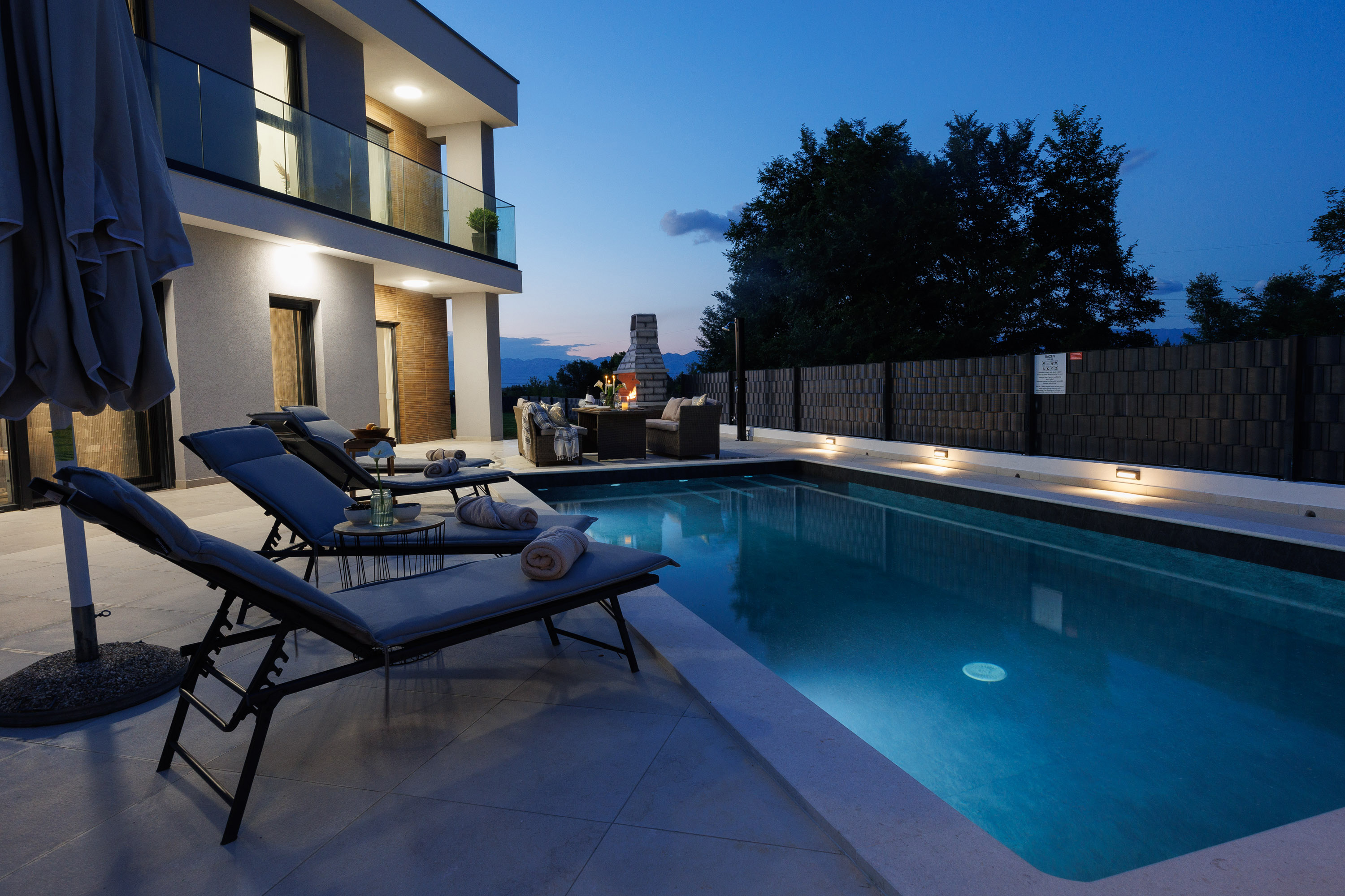 Pool loungers at night